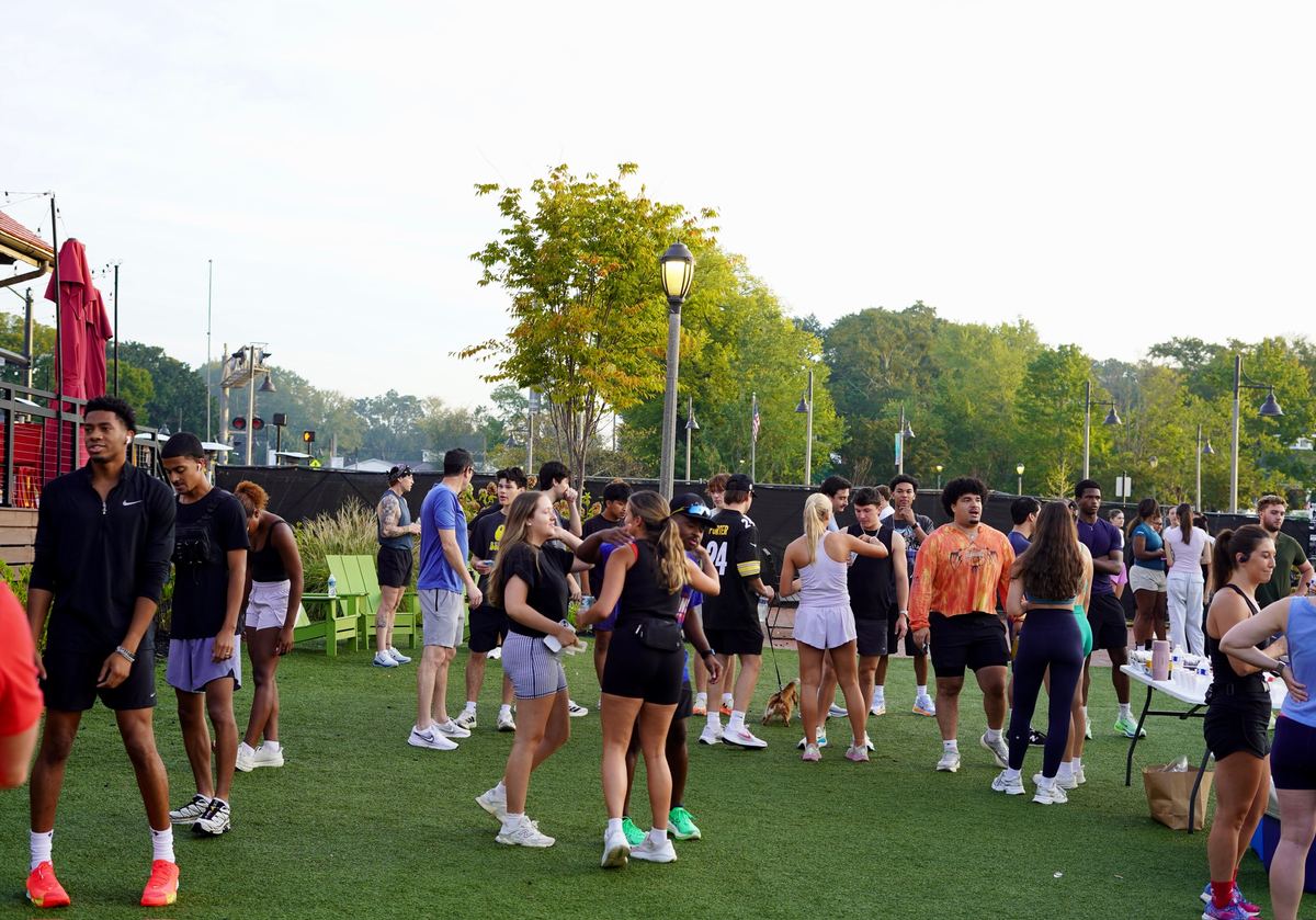 Runners spread across the turf chatting before the run